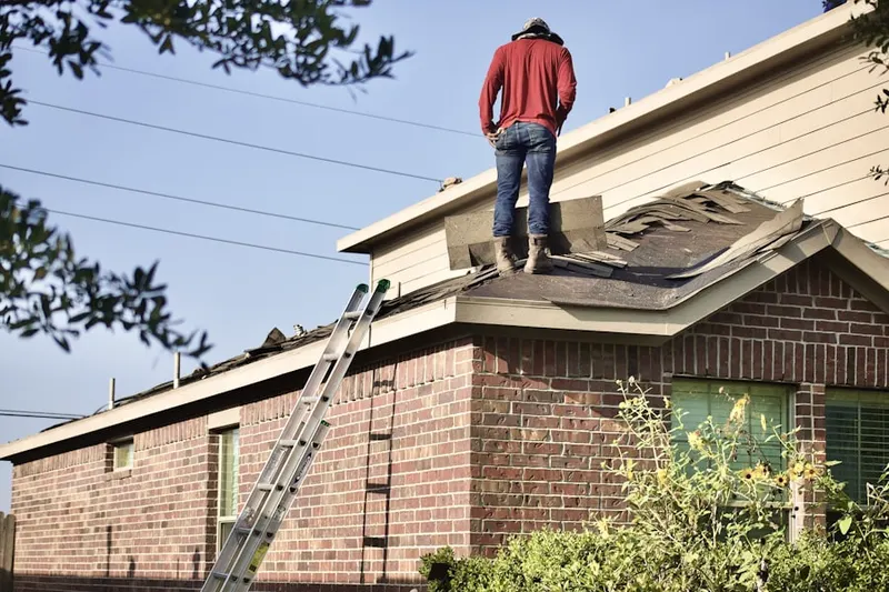 Professional roofer working on a residential roof in Elwyn